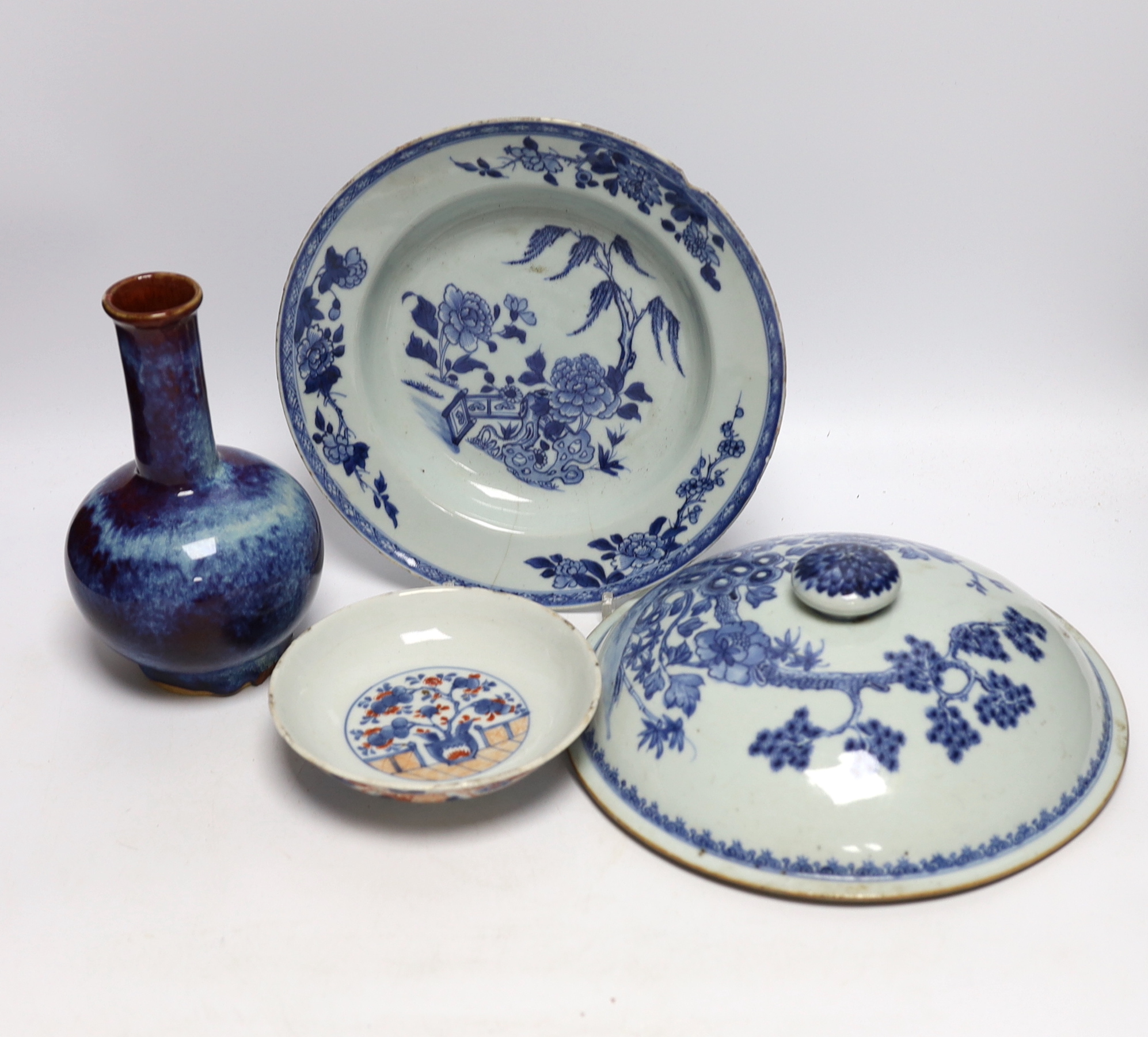A group of Chinese ceramics including a flambé vase, an 18th century blue and white floral plate and a similar lid, 25cm diameter